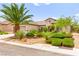 Charming home with lush landscaping, mature palm tree, and well-maintained front yard at 2227 Garden City Ave, Henderson, NV 89052