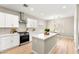 Modern kitchen with white cabinets, stainless steel appliances, marble countertops, and an island for extra space at 2227 Garden City Ave, Henderson, NV 89052