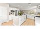 Open kitchen with stainless steel appliances, kitchen island, and modern white cabinets at 2227 Garden City Ave, Henderson, NV 89052