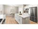 Bright kitchen with stainless steel appliances, a kitchen island, and an adjacent dining area at 2227 Garden City Ave, Henderson, NV 89052
