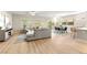 Spacious living room with wood floors, large sectional sofa, and sliding doors to the backyard at 2227 Garden City Ave, Henderson, NV 89052