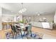 Open-concept living area features dining table, breakfast bar and comfortable seating area, all beautifully decorated at 2227 Garden City Ave, Henderson, NV 89052