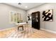 Bright office with natural light from shuttered window, modern desk, and striking black and white artwork at 2227 Garden City Ave, Henderson, NV 89052
