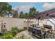 Relax in this outdoor living space featuring a charming pergola with comfortable seating and lush landscaping at 3157 Capetown Way, Las Vegas, NV 89128