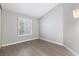 Light and airy bedroom featuring neutral walls, wood-look flooring, and plantation shutters at 3157 Capetown Way, Las Vegas, NV 89128