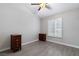 Spacious bedroom with a ceiling fan, natural light, and updated wood-look flooring at 3157 Capetown Way, Las Vegas, NV 89128