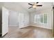 Large bedroom with wood-look flooring, a ceiling fan, and updated plantation shutters at 3157 Capetown Way, Las Vegas, NV 89128