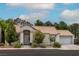 Charming single-story home with a well-manicured lawn, desert landscaping, and a tile roof at 3157 Capetown Way, Las Vegas, NV 89128
