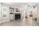 Bright living room featuring a fireplace, large windows, and light-colored wood flooring at 3157 Capetown Way, Las Vegas, NV 89128