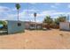 Spacious backyard with desert landscaping, a storage shed, and mature trees at 3200 E Owens Ave, North Las Vegas, NV 89030