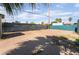 Large dirt backyard with chain link fence, palm trees, and shed at 3200 E Owens Ave, North Las Vegas, NV 89030