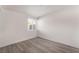Bright bedroom features modern gray flooring and natural light from the window at 3200 E Owens Ave, North Las Vegas, NV 89030