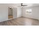 Bright bedroom features new wood-look flooring, a ceiling fan and a window for natural light at 3200 E Owens Ave, North Las Vegas, NV 89030