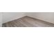 Bedroom features modern light wood floors and white baseboards at 3200 E Owens Ave, North Las Vegas, NV 89030
