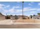 Single-story home with a fenced front yard and low maintenance landscaping in a residential neighborhood at 3200 E Owens Ave, North Las Vegas, NV 89030