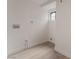 Laundry room featuring modern flooring, window, and utility hookups at 3200 E Owens Ave, North Las Vegas, NV 89030