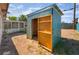 Backyard storage shed with an open door surrounded by desert landscaping at 3200 E Owens Ave, North Las Vegas, NV 89030