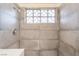 Modern tiled shower with sleek fixtures and window at 3200 E Owens Ave, North Las Vegas, NV 89030
