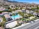 Aerial view of the community pool and well-kept lawns with palm trees at 3205 Rainmaker St, Las Vegas, NV 89129
