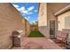 This backyard has brick pavers, artificial turf, and a stainless steel grill at 3205 Rainmaker St, Las Vegas, NV 89129