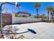 Private basketball court with a brick wall and tall palm trees at 3205 Rainmaker St, Las Vegas, NV 89129
