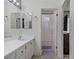 A bathroom featuring double sinks and a shower with a white curtain at 3205 Rainmaker St, Las Vegas, NV 89129