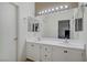 Bathroom with double sinks, a large mirror and white cabinetry at 3205 Rainmaker St, Las Vegas, NV 89129