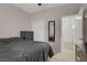 Bedroom featuring a queen bed, a ceiling fan, and access to a mirror and a hallway at 3205 Rainmaker St, Las Vegas, NV 89129