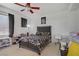 Bedroom featuring a ceiling fan, a queen bed, dark curtains and a dark decor at 3205 Rainmaker St, Las Vegas, NV 89129