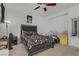 A bedroom with a queen bed, a ceiling fan, and a minimalist design at 3205 Rainmaker St, Las Vegas, NV 89129