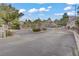 A view of the gated entrance to the community with manicured shrubs and block pillars at 3205 Rainmaker St, Las Vegas, NV 89129