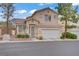Charming two-story home features a well-maintained front yard, two-car garage, and a red tile roof at 3205 Rainmaker St, Las Vegas, NV 89129