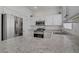 Stylish kitchen featuring stainless steel appliances, white cabinets, and a breakfast bar area at 3205 Rainmaker St, Las Vegas, NV 89129