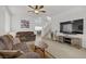 Inviting living room with neutral tones, a ceiling fan, and ample space for comfortable seating at 3205 Rainmaker St, Las Vegas, NV 89129
