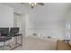Bright loft area with carpet, a ceiling fan, and railing overlooking downstairs at 3205 Rainmaker St, Las Vegas, NV 89129