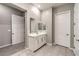 Bright bathroom featuring a single sink vanity with modern fixtures and neutral tile floors at 326 Beethoven Ridge Dr, Henderson, NV 89011