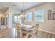 Dining area features wood-look floors, modern chandelier, and sliding glass doors at 326 Beethoven Ridge Dr, Henderson, NV 89011