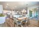 Open-concept kitchen and dining area with modern lighting, stainless steel appliances, and seamless access to outdoor patio at 326 Beethoven Ridge Dr, Henderson, NV 89011