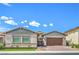 Charming single-story home featuring a two-car garage, desert landscaping, and a welcoming facade on a sunny day at 326 Beethoven Ridge Dr, Henderson, NV 89011