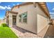 Attractive home exterior with a covered patio, artificial grass, and a brick walkway at 326 Beethoven Ridge Dr, Henderson, NV 89011