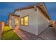 Beautiful home exterior with artificial grass, paved patio, and covered seating area at 326 Beethoven Ridge Dr, Henderson, NV 89011
