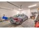 Clean, organized garage featuring car, storage racks, overhead lighting, and door to another room at 326 Beethoven Ridge Dr, Henderson, NV 89011