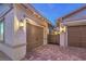 Attached two-car garage with beautiful brick-paved driveway and desert landscaping, offering a blend of style and convenience at 326 Beethoven Ridge Dr, Henderson, NV 89011