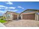 Attached two-car garage with beautiful brick-paved driveway and desert landscaping, on a sunny day at 326 Beethoven Ridge Dr, Henderson, NV 89011