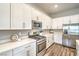 Bright, modern kitchen featuring stainless steel appliances, quartz countertops, and ample cabinet space for stylish functionality at 326 Beethoven Ridge Dr, Henderson, NV 89011