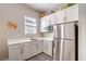 Modern kitchen with white cabinets, stainless steel appliances, and bright countertops at 326 Beethoven Ridge Dr, Henderson, NV 89011