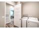 Laundry room with full-size washer and dryer next to an entry to another room at 326 Beethoven Ridge Dr, Henderson, NV 89011
