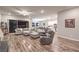 Bright living room with wood floors, large gray couch, and sliding glass door leading to patio at 326 Beethoven Ridge Dr, Henderson, NV 89011