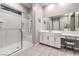 Main bathroom with glass enclosed shower, makeup vanity, and large mirror at 326 Beethoven Ridge Dr, Henderson, NV 89011