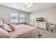 Bright main bedroom featuring a blush quilt, television, and private door to the exterior at 326 Beethoven Ridge Dr, Henderson, NV 89011